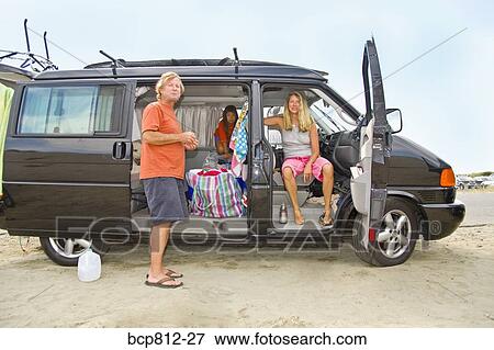 Stock Photo - Family relaxing in traveling van. Fotosearch