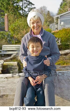 Grandmother hugging Asian grandson View Large Photo Image Stock Image - Grandmother hugging Asian grandson. Fotosearch