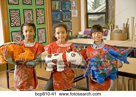 Multi-ethnic girls holding art projects View Large Photo Image Stock Image - Multi-ethnic girls holding art projects. Fotosearch