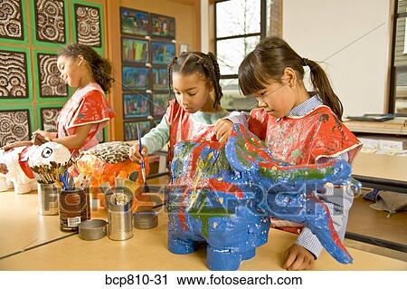 Stock Image - Multi-ethnic girls making art projects. Fotosearch