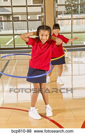 Multi-ethnic girls playing with hula hoops View Large Photo Image Stock Photo - Multi-ethnic girls playing with hula hoops. Fotosearch