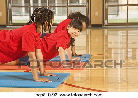 Multi-ethnic girls practicing yoga View Large Photo Image Stock Image - Multi-ethnic girls practicing yoga. Fotosearch