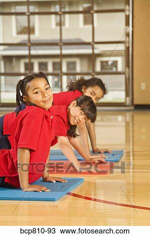 Stock Image - Multi-ethnic girls practicing yoga. Fotosearch