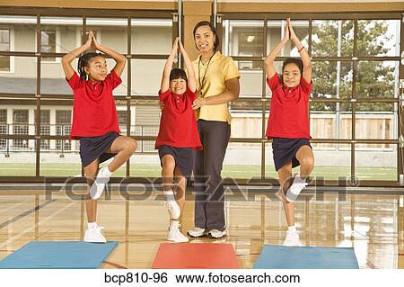 Multi-ethnic girls practicing yoga View Large Photo Image Stock Photograph - Multi-ethnic girls practicing yoga. Fotosearch