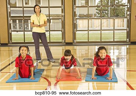 Stock Photography - Multi-ethnic girls practicing yoga. Fotosearch