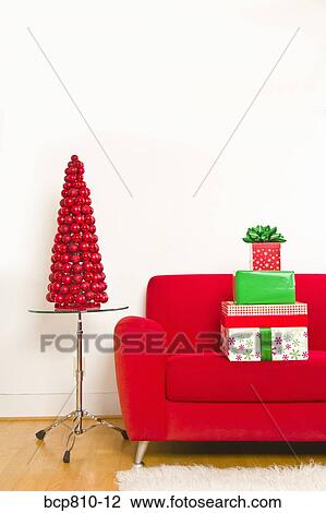 Stack of Christmas gifts on sofa View Large Photo Image Stock Image - Stack of Christmas gifts on sofa. Fotosearch