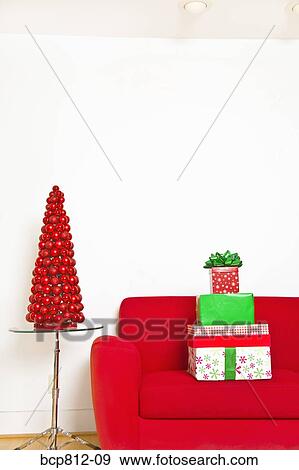 Stack of Christmas gifts on sofa View Large Photo Image Stock Photo - Stack of Christmas gifts on sofa. Fotosearch