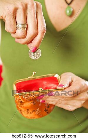 Woman dropping coin in purse View Large Photo Image Stock Photography - Woman dropping coin in purse. Fotosearch
