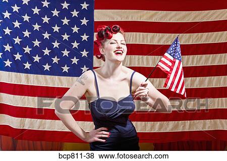 Woman holding American flag View Large Photo Image Stock Photo - Woman holding American flag. Fotosearch
