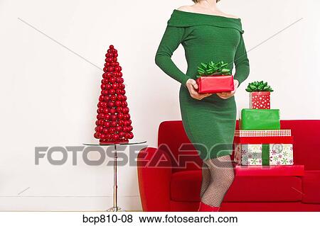 Woman holding Christmas gift View Large Photo Image Stock Photo - Woman holding Christmas gift. Fotosearch