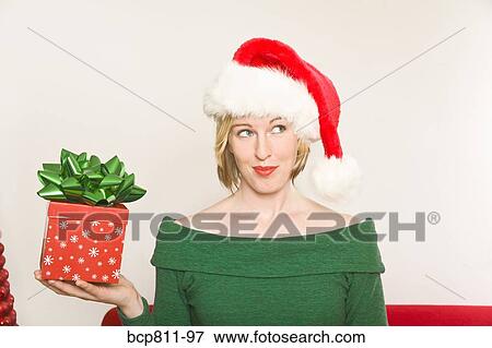 Woman holding Christmas gift View Large Photo Image Stock Photo - Woman holding Christmas gift. Fotosearch