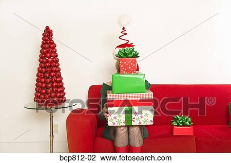 Woman holding stack of Christmas gifts View Large Photo Image Stock Image - Woman holding stack of Christmas gifts. Fotosearch