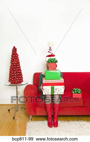 Woman holding stack of Christmas gifts View Large Photo Image Stock Photo - Woman holding stack of Christmas gifts. Fotosearch