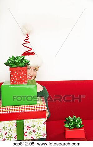 Woman holding stack of Christmas gifts View Large Photo Image Stock Photography - Woman holding stack of Christmas gifts. Fotosearch
