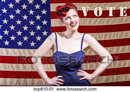 Stock Image - Woman in front of American flag. Fotosearch