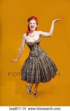 Picture - Woman wearing strapless evening gown. Fotosearch
