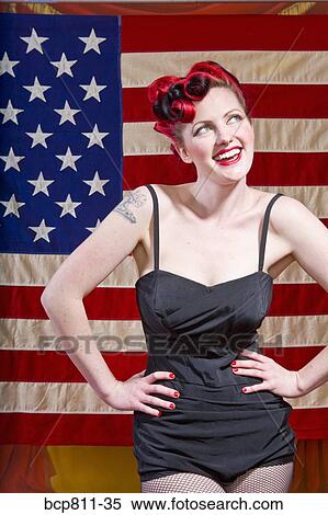 Woman with hands on hips in front of American flag View Large Photo Image Stock Photography - Woman with hands on hips in front of American flag. Fotosearch