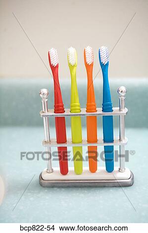 Assorted colorful toothbrushes in stand View Large Photo Image Picture - Assorted colorful toothbrushes in stand. Fotosearch
