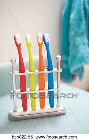 Assorted colorful toothbrushes in stand View Large Photo Image Stock Photography - Assorted colorful toothbrushes in stand. Fotosearch