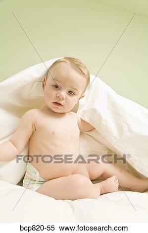 Baby sitting under blanket in bed View Large Photo Image Stock Photography - Baby sitting under blanket in bed. Fotosearch
