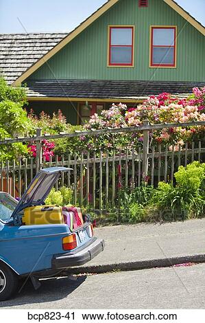 Car trunk loaded with colorful suitcases in front of house View Large Photo Image Stock Image - Car trunk loaded with colorful suitcases in front of house. Fotosearch