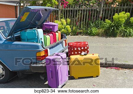 Car trunk loaded with colorful suitcases View Large Photo Image Picture - Car trunk loaded with colorful suitcases. Fotosearch