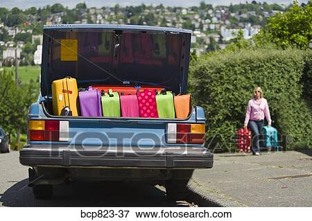 Car trunk loaded with colorful suitcases View Large Photo Image Stock Photo - Car trunk loaded with colorful suitcases. Fotosearch