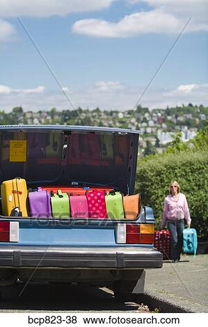 Car trunk loaded with colorful suitcases View Large Photo Image Stock Photo - Car trunk loaded with colorful suitcases. Fotosearch
