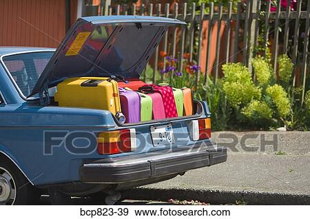 Car trunk loaded with colorful suitcases View Large Photo Image Stock Photo - Car trunk loaded with colorful suitcases. Fotosearch