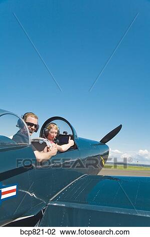 Man and woman sitting in vintage airplane View Large Photo Image Stock Image - Man and woman sitting in vintage airplane. Fotosearch