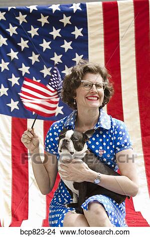 Patriotic woman and Boston Terrier dog posing with American flag View Large Photo Image Picture - Patriotic woman and Boston Terrier dog posing with American flag. Fotosearch