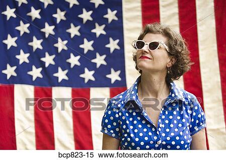Patriotic woman posing with American flag View Large Photo Image Stock Photography - Patriotic woman posing with American flag. Fotosearch