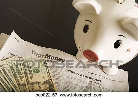 Piggy bank, cash and financial section of newspaper View Large Photo Image Stock Photo - Piggy bank, cash and financial section of newspaper. Fotosearch