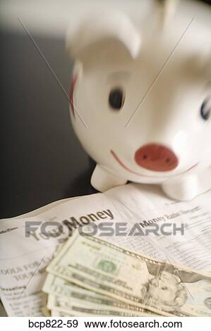 Piggy bank, cash and financial section of newspaper View Large Photo Image Stock Photo - Piggy bank, cash and financial section of newspaper. Fotosearch