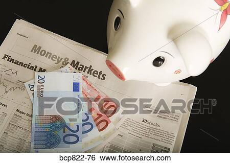 Stock Photograph - Piggy bank, cash and financial section of newspaper. Fotosearch