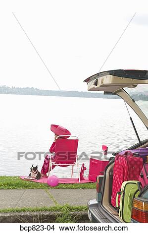 Woman and dog relaxing by bay View Large Photo Image Picture - Woman and dog relaxing by bay. Fotosearch