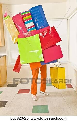 Woman balancing assorted shopping bags View Large Photo Image Stock Image - Woman balancing assorted shopping bags. Fotosearch