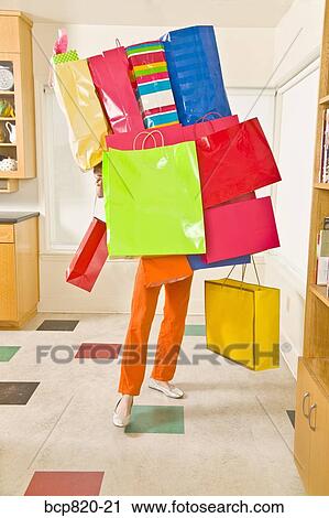 Woman balancing assorted shopping bags View Large Photo Image Stock Image - Woman balancing assorted shopping bags. Fotosearch