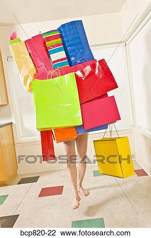 Woman balancing assorted shopping bags View Large Photo Image Stock Image - Woman balancing assorted shopping bags. Fotosearch