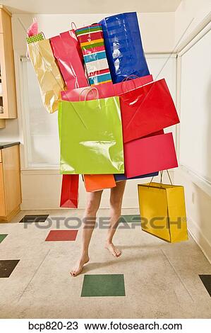Woman balancing assorted shopping bags View Large Photo Image Stock Image - Woman balancing assorted shopping bags. Fotosearch