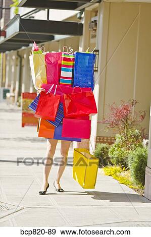 Woman balancing assorted shopping bags View Large Photo Image Stock Photo - Woman balancing assorted shopping bags. Fotosearch