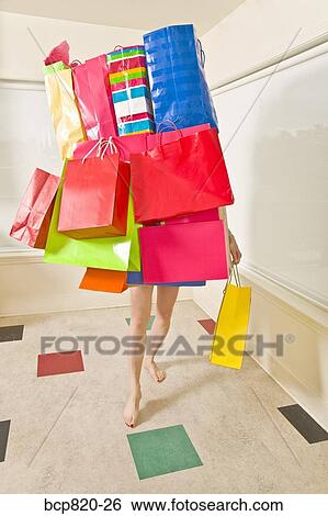 Woman balancing assorted shopping bags View Large Photo Image Stock Photograph - Woman balancing assorted shopping bags. Fotosearch