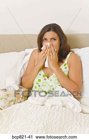 Woman blowing nose in bed View Large Photo Image Stock Image - Woman blowing nose in bed. Fotosearch