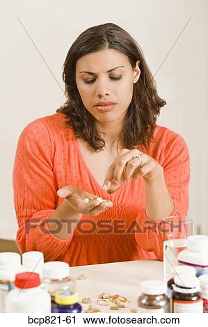 Woman holding handful of vitamins and supplements View Large Photo Image Stock Image - Woman holding handful of vitamins and supplements. Fotosearch