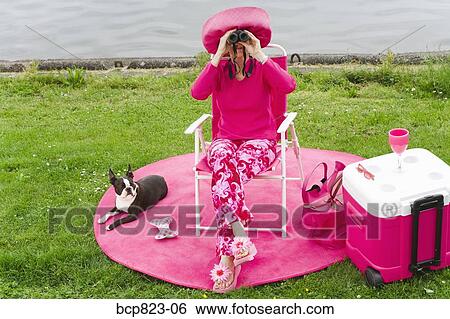 Woman in pink and dog picnicking by water View Large Photo Image Stock Photograph - Woman in pink and dog picnicking by water. Fotosearch