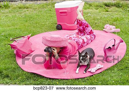 Woman in pink and dog picnicking View Large Photo Image Stock Photo - Woman in pink and dog picnicking. Fotosearch