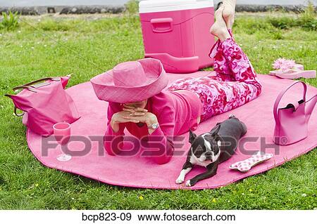 Woman in pink and dog picnicking View Large Photo Image Stock Photo - Woman in pink and dog picnicking. Fotosearch