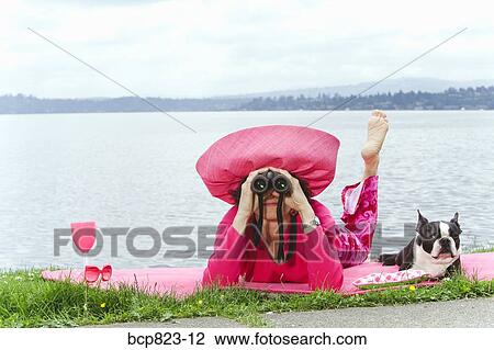 Woman in pink and dog relaxing by bay View Large Photo Image Stock Image - Woman in pink and dog relaxing by bay. Fotosearch