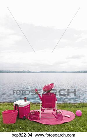 Woman in pink picnicking by bay View Large Photo Image Picture - Woman in pink picnicking by bay. Fotosearch