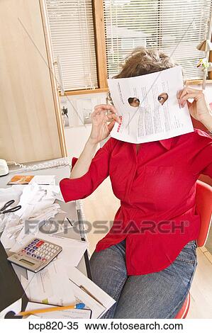Woman looking through holes in document in home office View Large Photo Image Stock Photography - Woman looking through holes in document in home office. Fotosearch